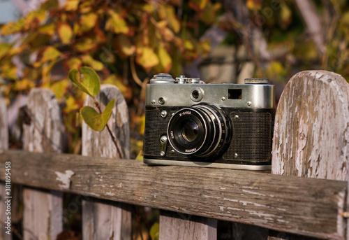 Old camera in nature on a Sunny autumn day.