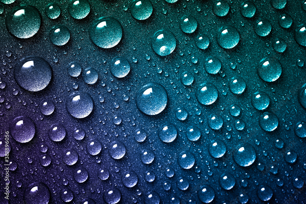 Lots of water drops splashed on a bright blue and green background. Abstract droplets close up