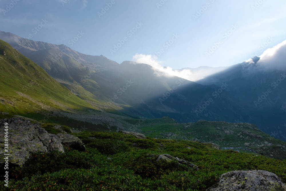 Sunrise in a high mountain valley overlooking the mountain pass. Hanging valley of the Koshtansu river. Caucasus.