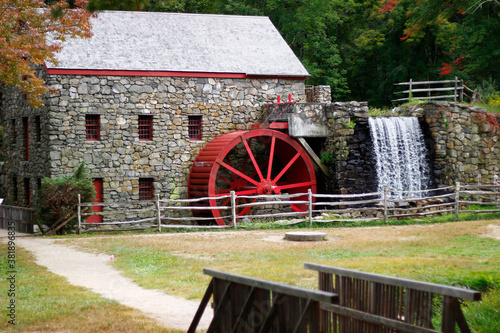 The Wayside Inn Grist Mill with water wheel and cascade water fall in Autumn, Sudbury, Massachusetts