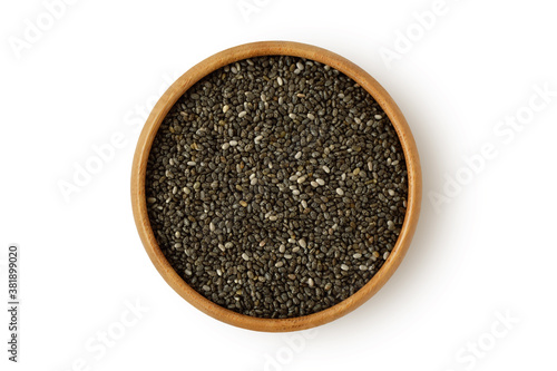 Chia seeds in wooden bowl on white background