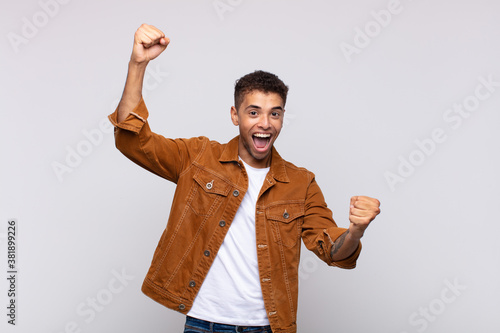  shouting triumphantly, looking like excited, happy and surprised winner, celebrating