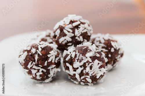 Closeup on chocolate treats covered in coconut flakes