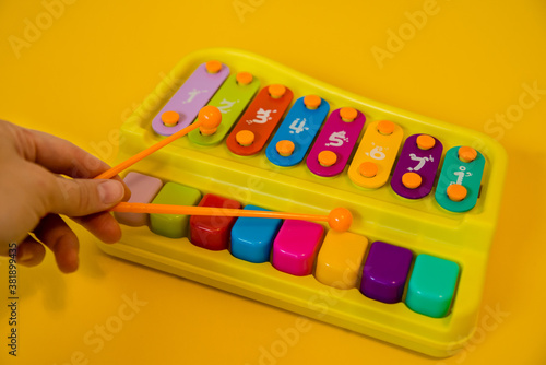 the hand holds the sticks over the xylophone. Children's musical toy. Educational games for kids.