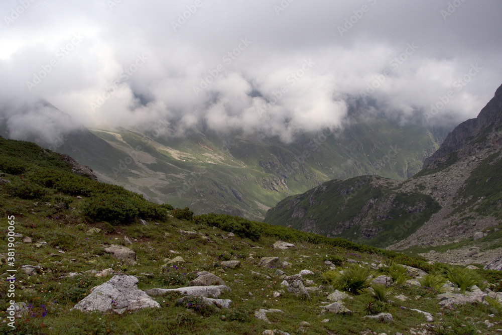 Alpine valley in the clouds. Kabardino-Balkarian natural reserve. Caucasus, Russia. Alpine valley in the clouds. Kabardino-Balkarian natural reserve. Caucasus, Russia.