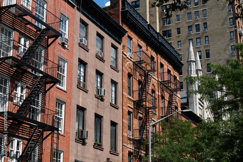 Row of Colorful Old Brick Residential Buildings with Fire Escapes in Greenwich Village of New York City © James