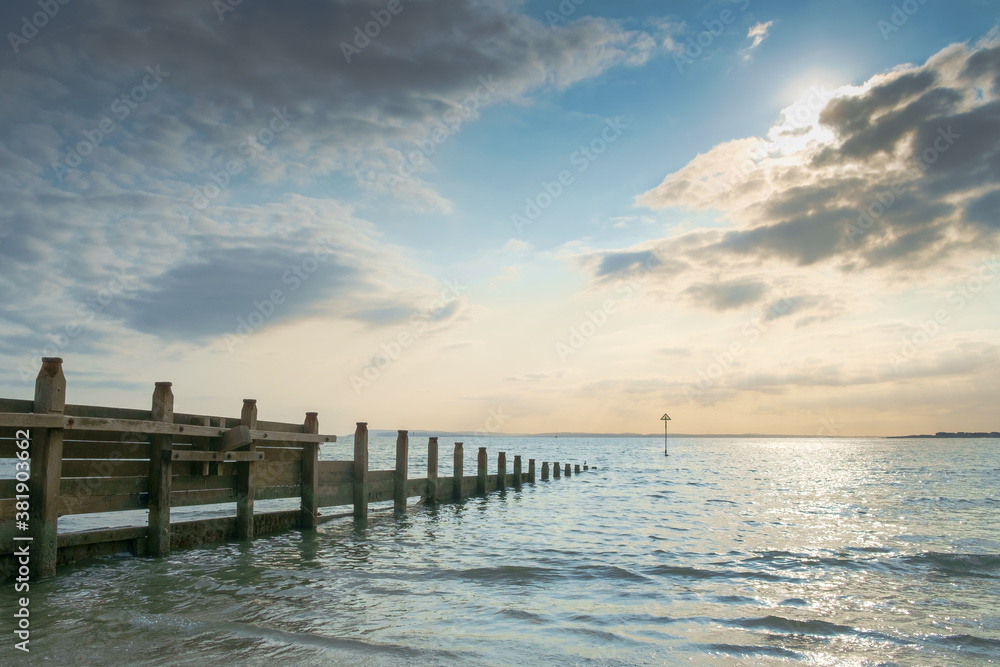 East Head, West Wittering, Chichester Harbour, England. A tranquil evening scene of partly cloudy sky and calm a sea.