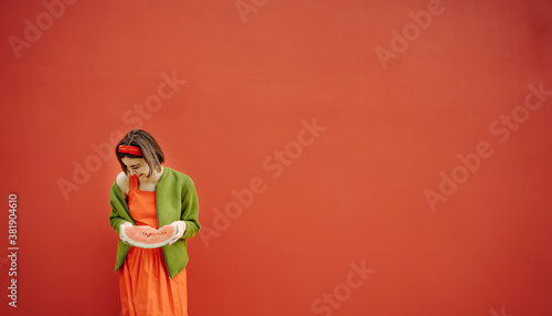 Happy laughing young girl with watermelon Horizontal long red banner. brunette girl Bob cut hair style red dress and green jacket. Having fun youth concept. accessories. Emotional positive artistic