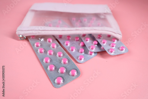 close up of blister packs on pink background 