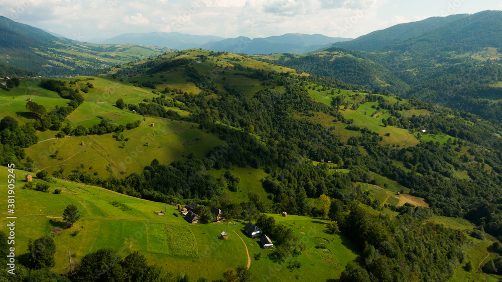 Few houses on the top of Carpathian mountains. Green meadow with great green lawn on it. Beautiful place for ecotourism. Few houses on the top of Carpathian mountains. Green meadow with great green lawn on it. Beautiful place for ecotourism.