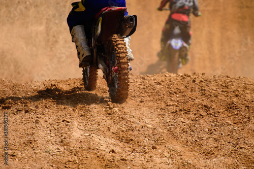 motocross show racer accelerating in dirt track