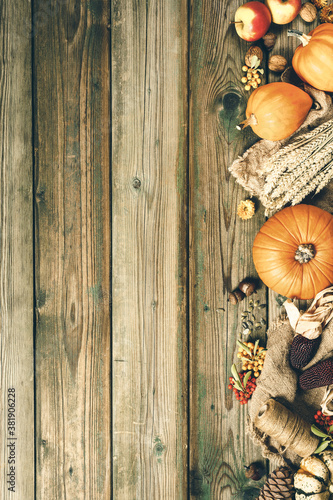 Autumn background - fallen leaves and healthy food on old wooden table. Thanksgiving day concept, copy space