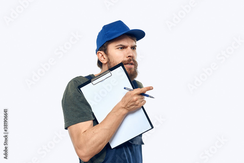 man in working uniform documents delivery loader transportation light background
