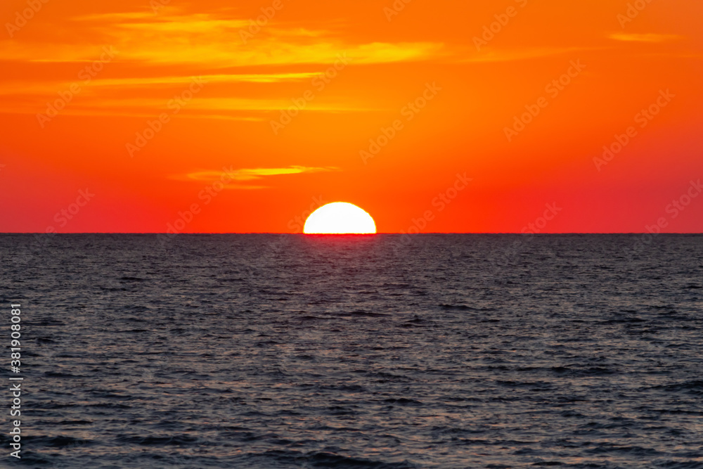 scarlet sunset over the sea, the sun set over the horizon