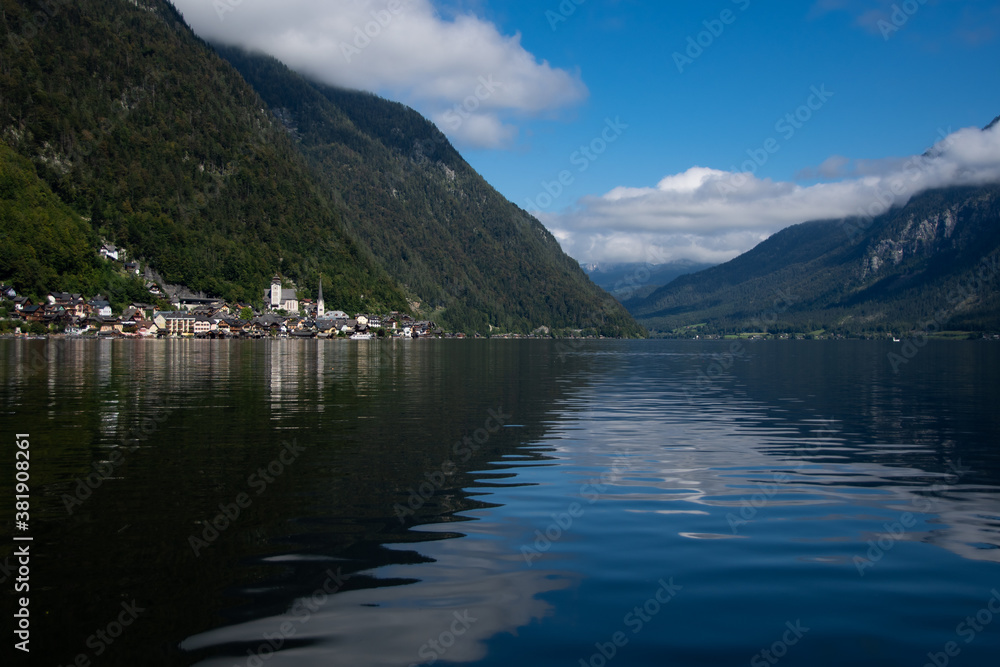 The small town of Hallstatt is located directly on the lake when the weather is nice and some clouds The small town of Hallstatt is located directly on the lake when the weather is nice and some clouds