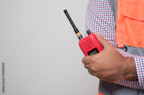 Wallpaper Mural Close up male hand civil engineer holding radio walkie talkie standing in studio isolated white background.. Torontodigital.ca