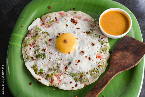 Omelette, omelet  boiled egg with Onions, green chillie, coriander, curry leaves, tomato in frying pan in Kerala, India. IndiaStreet food bred omlet. Ready to eat masala egg half boiled omeletts photo