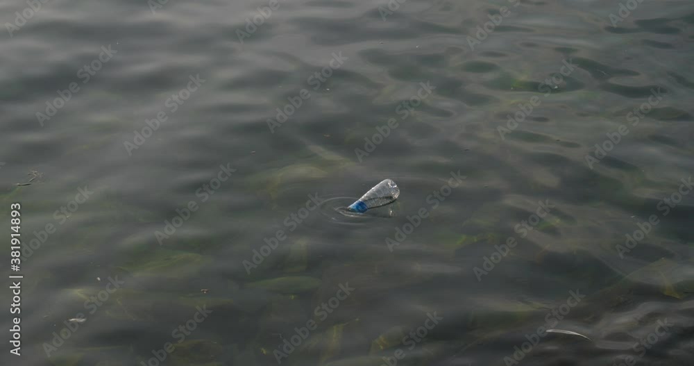 A plastic bottle contaminated the sea, garbage that we throw into the ocean that affects our health, viruses and diseases caused by the poor state of the environment A plastic bottle contaminated the sea, garbage that we throw into the ocean that affects our health, viruses and diseases caused by the poor state of the environment
