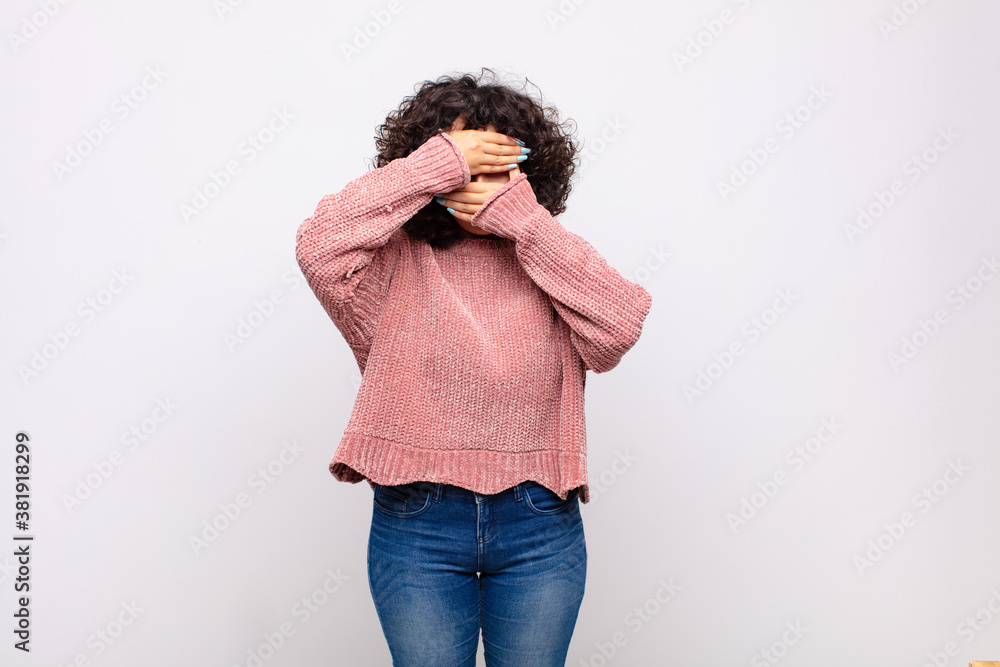 covering face with both hands saying no to the camera! refusing ...