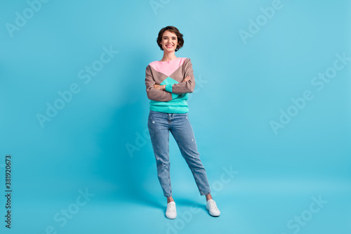 Photo portrait full body of cheerful girl standing with folded hands isolated on pastel light blue colored background