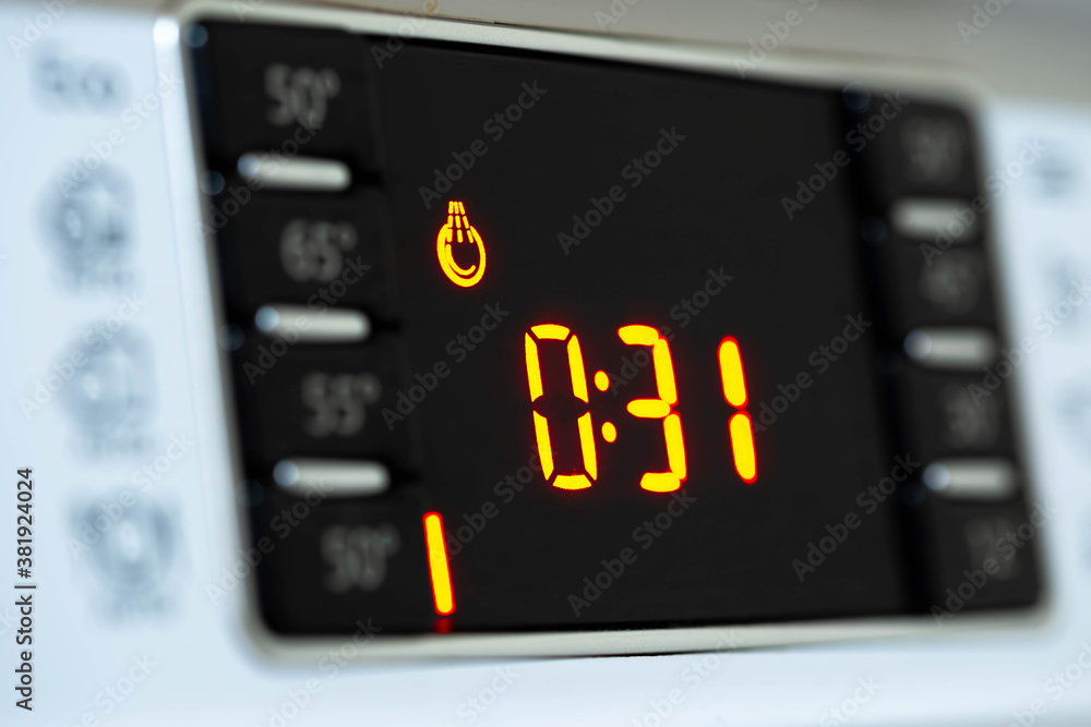 Digital display on dishwasher machine counting down the remained time close up shot. Digital display on dishwasher machine counting down the remained time close up shot.