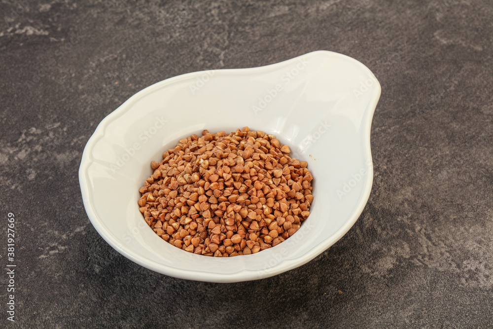 Raw buсkwheat cereal in the bowl Raw buсkwheat cereal in the bowl