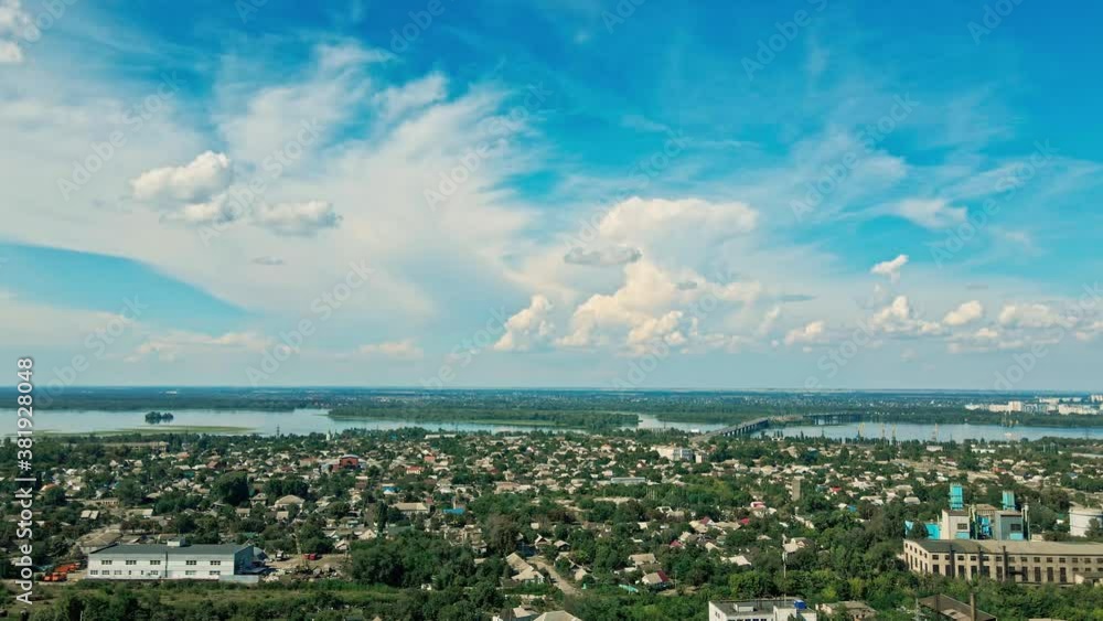aerial landscape with green city part, big river and beautiful blue sky with white clouds. drone flight over residential city district aerial landscape with green city part, big river and beautiful blue sky with white clouds. drone flight over residential city district