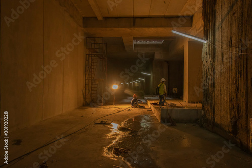 light illuminated the construction site. Workers were sitting on the subway tunnels. working in tunnels and limited spaces