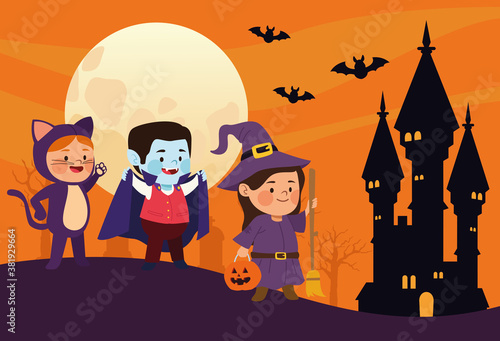 cute little kids dressed as a cat and witch with dracula in castle scene
