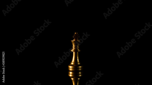 lonely golden king chess standing in the dark.