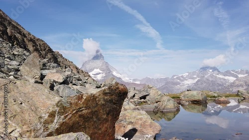 Reflection of Mount Matterhorn on Riffelsee Lake in Zermatt, mountain resort in Swiss Alps, Canton of Valais, Switzerland. Riffelsee is located on Riffelseeweg trail on Gornergrat Bahn cog railway. photo