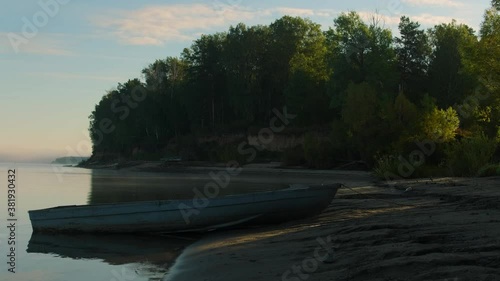 Summer landscape. Wooden boat and calm river .Rural landscape