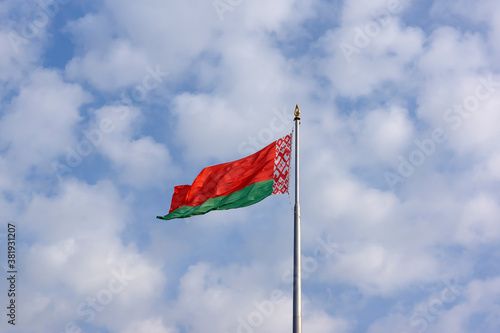 State flag of the Republic of Belarus against the sky. photo