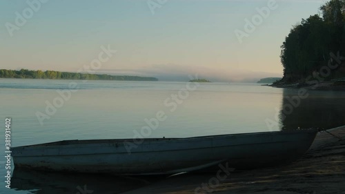 Summer landscape. Wooden boat and calm river .Rural landscape