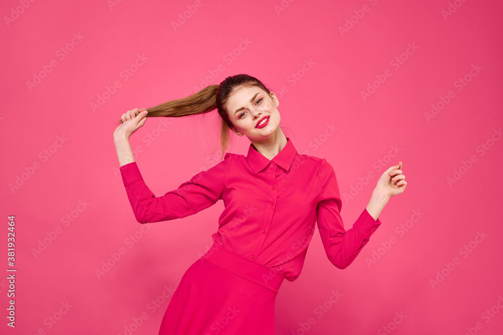 Portrait of a red-haired woman in bright clothes on a pink background cropped view of gesturing with her hands Portrait of a red-haired woman in bright clothes on a pink background cropped view of gesturing with her hands