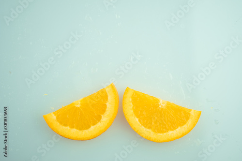 Bright halves of thin slice oranges. Flat lay