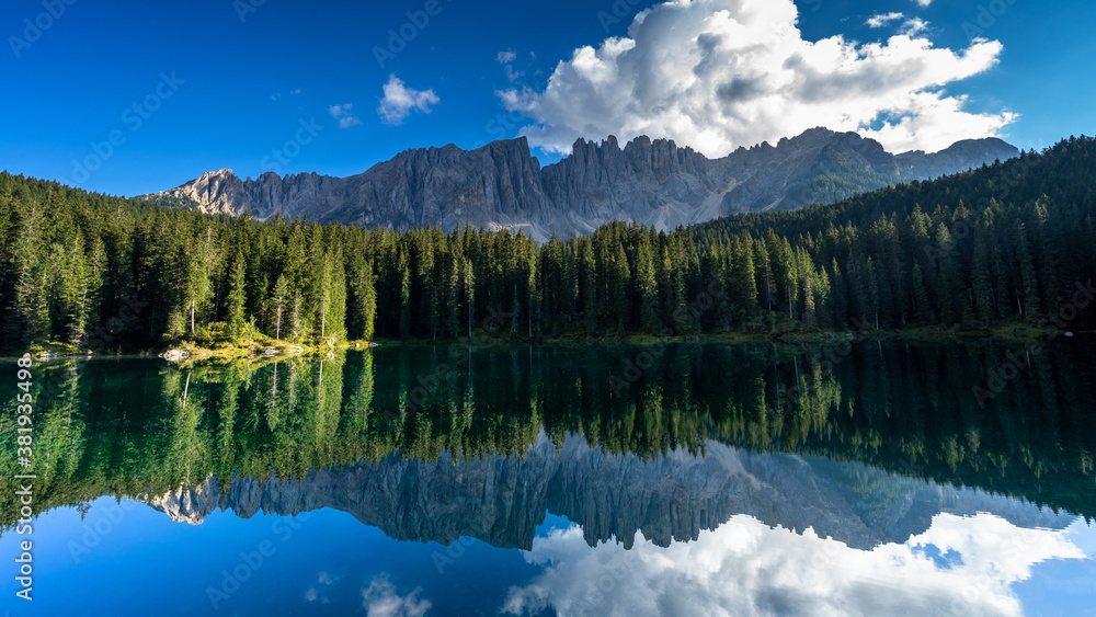 Carezza lake, Mount Latemar, Bolzano province, South tyrol, Italy. Landscape of Lake Carezza or Karersee and Dolomites in background, Nova Levante, Bolzano, Italy.