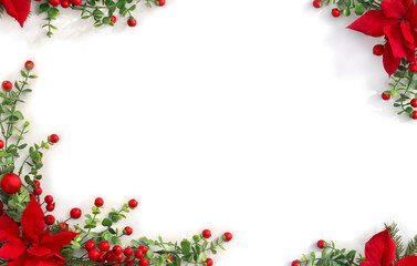 Christmas decoration. Frame of flowers of red poinsettia, branch christmas tree, red berries on white background with space for text. Top view, flat lay