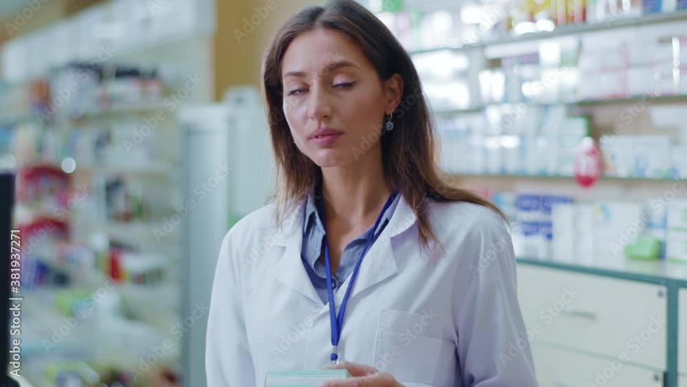 Portrait of nice caucasian beautiful smart woman apothecarist searching medicine in computer database looking seriously. Pharmacist woman. Drugstore concept. Portrait of nice caucasian beautiful smart woman apothecarist searching medicine in computer database looking seriously. Pharmacist woman. Drugstore concept.