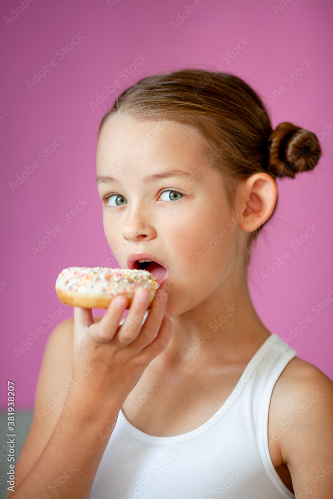 cute girl holding an appetizing glazed donut in her hands cute girl holding an appetizing glazed donut in her hands