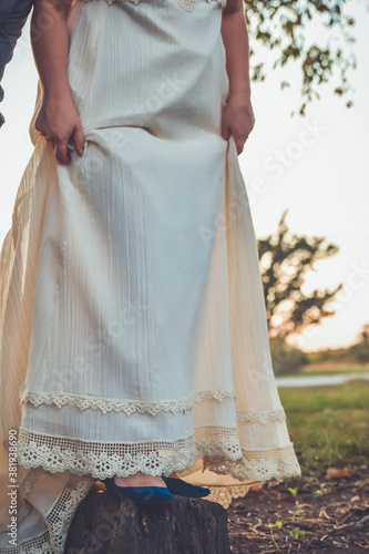 bride in a vintage dress with flat blue shoes