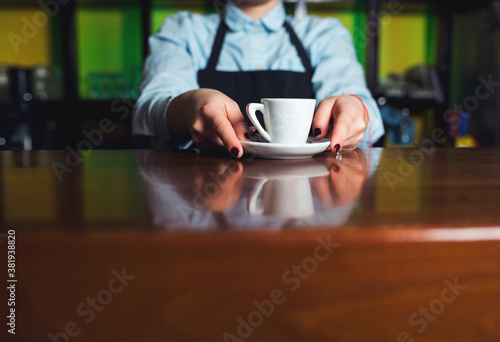Barman serving cup of coffee