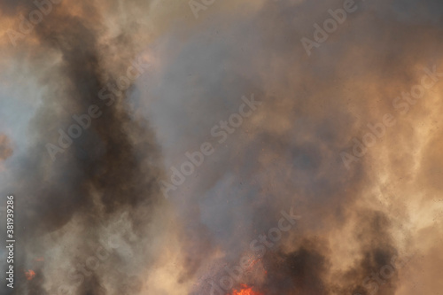 raging dust smoke pattern background of fire burn in grass fields, forests and black