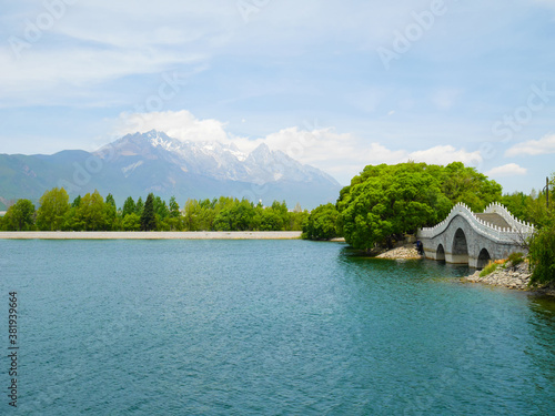 Qingxi reservoir and beautiful bridge with Jade Dragon Snow Mountain in the background