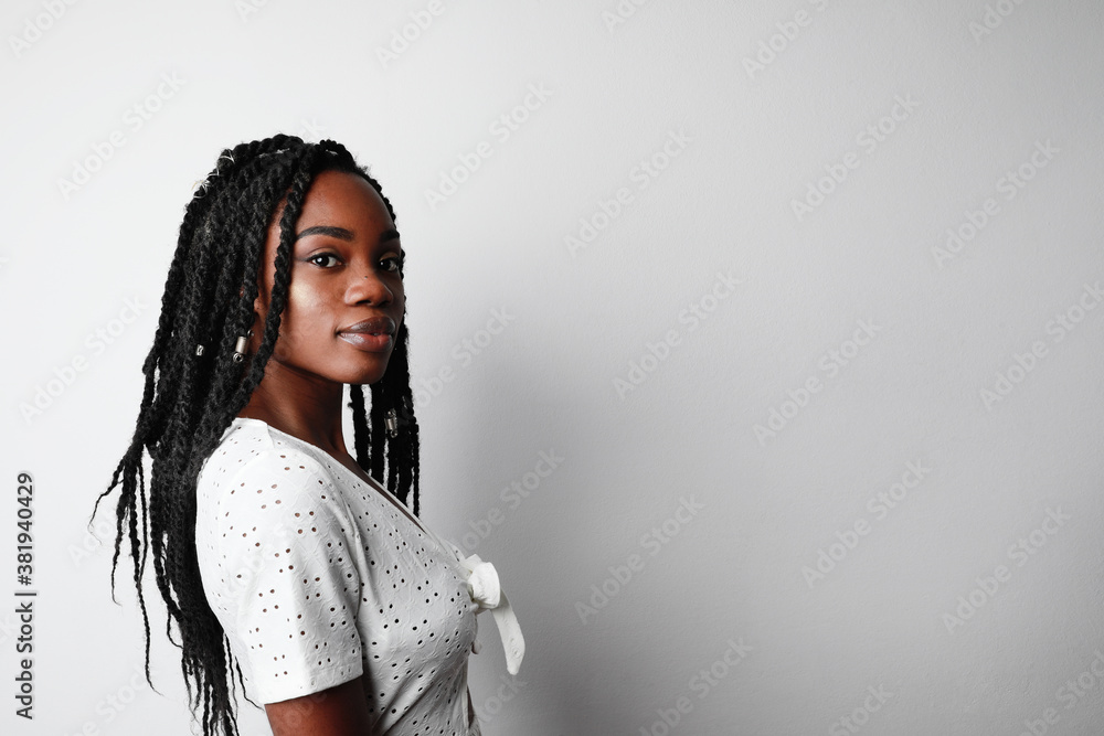 Side portrait of pretty young African American woman posing on white background, lifestyle people concept. Side portrait of pretty young African American woman posing on white background, lifestyle people concept.