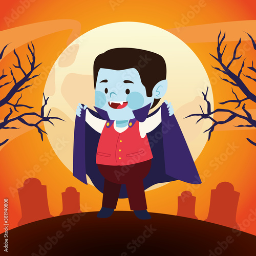 cute little boy dressed as a dracula character in cemetery