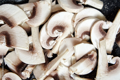 Fresh sliced white champignons closeup