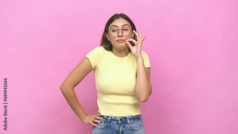 Young caucasian woman with fingers on lips keeping a secret Young caucasian woman with fingers on lips keeping a secret