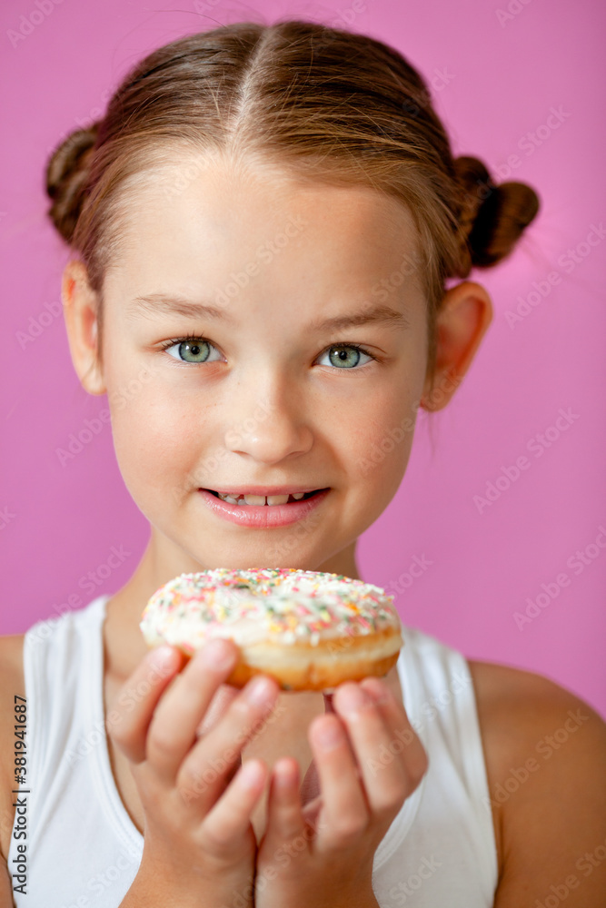 cute girl holding an appetizing glazed donut in her hands cute girl holding an appetizing glazed donut in her hands