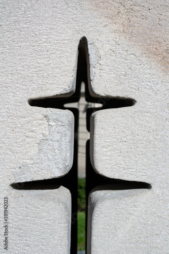 Cross on white wall - hole, aperture, interstice and slit as religious symbol of christianity and christian religion. 